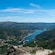 A lush mountainous valley overlooking the water with houses dotting the countryside